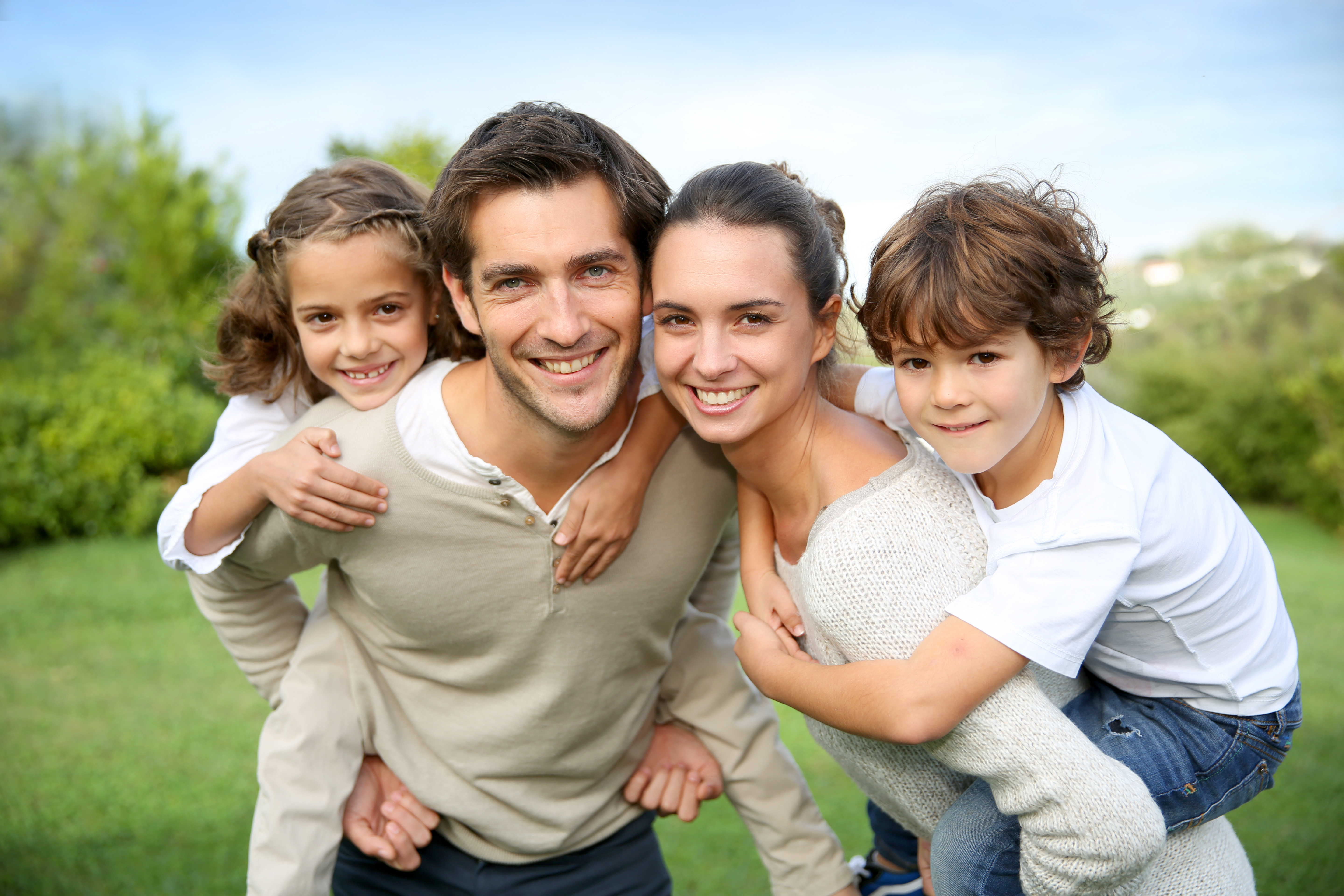 Parents giving piggyback ride to children