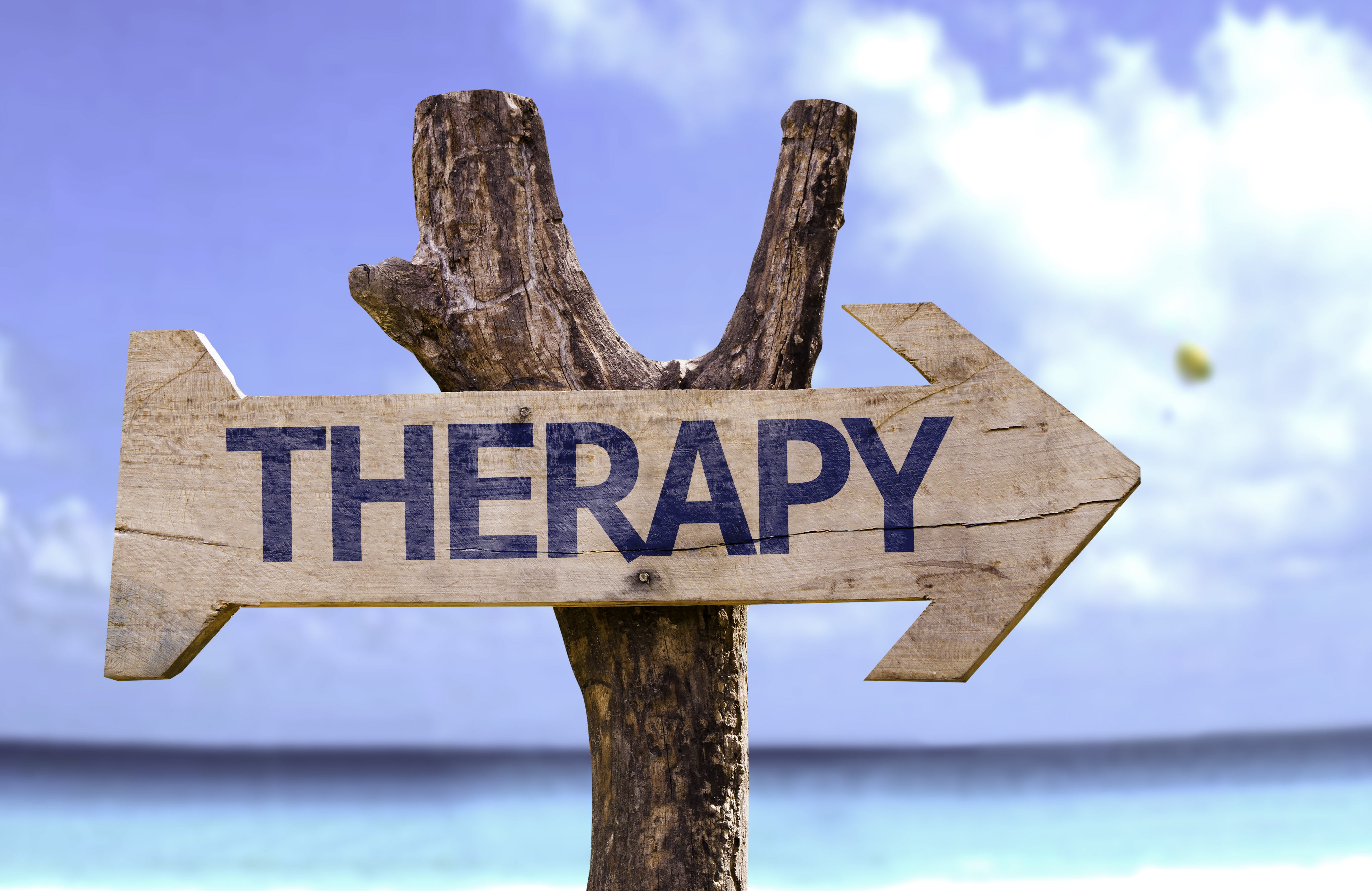 Therapy wooden sign with a beach on background-1